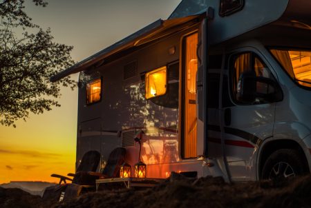 Scenic RV Camping Spot During Sunset. Class C Motorhome Camper Van. Travel Industry Theme.